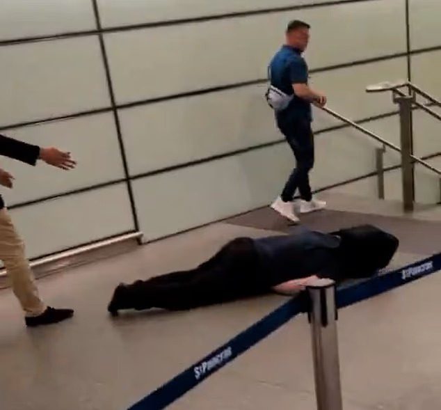 Tommy Robinson walks away from unconscious man after an altercation at St Pancras station